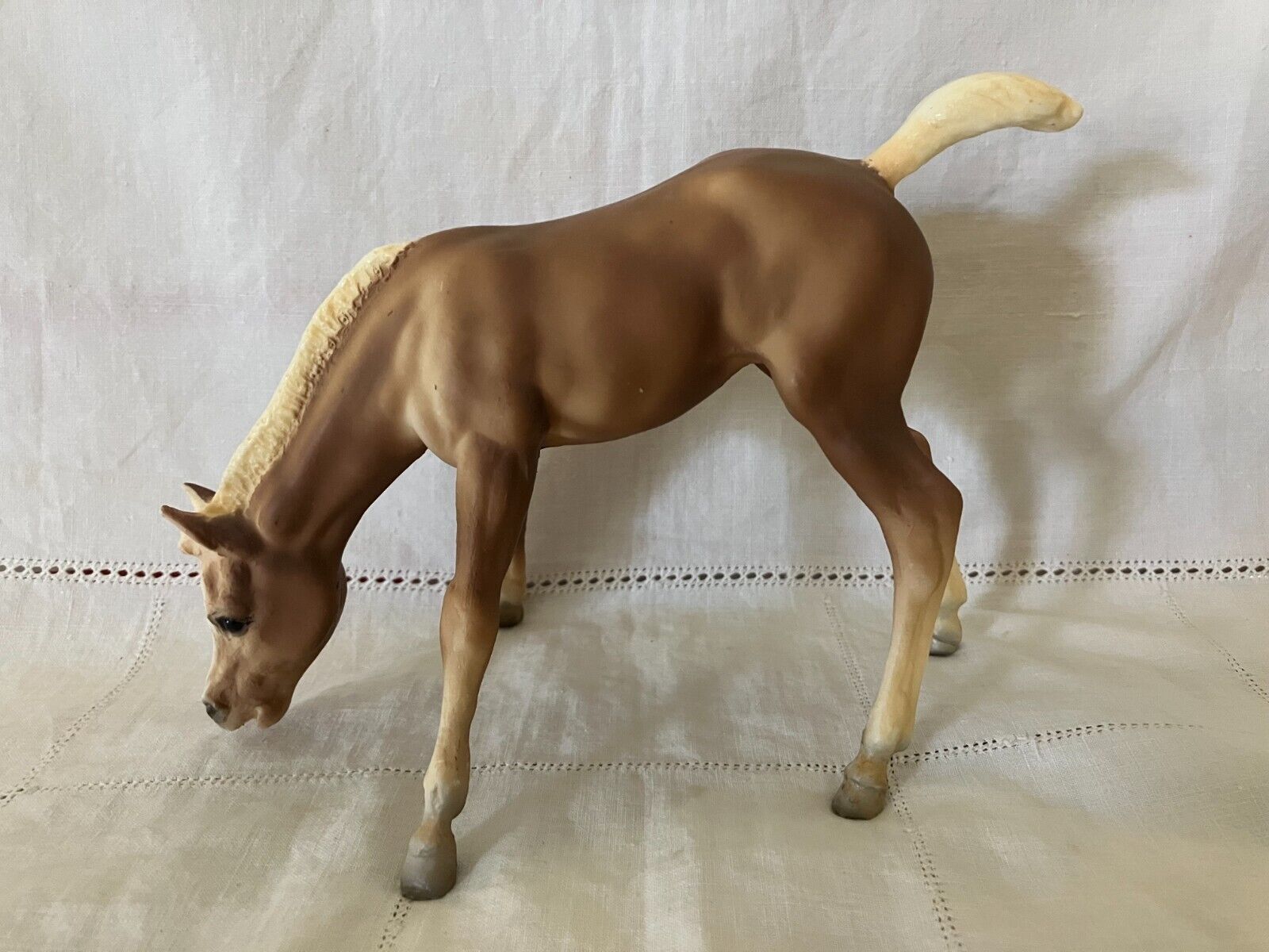 Breyer horse grazing foal