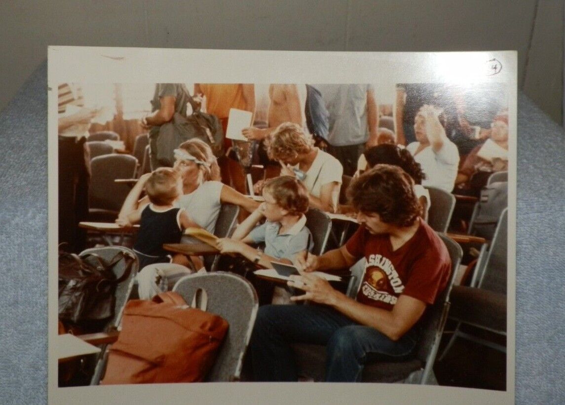 Circa 1983 Color Press Photo-Airport in Grenada-Man Wearing Redskins T-Shirt