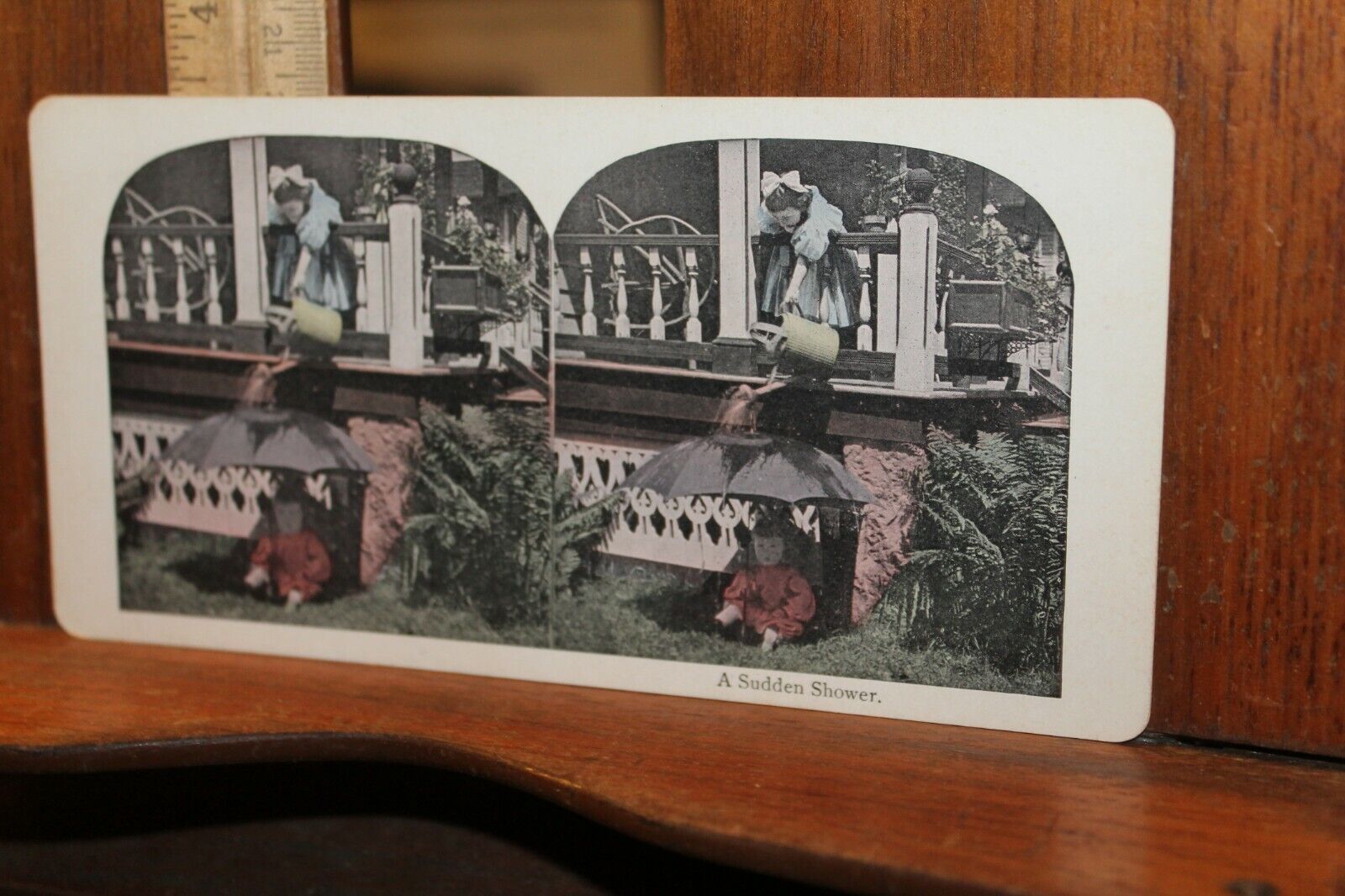 Antique Stereoview Card A Sudden Shower Girl Dumping Water on Baby Umbrella 