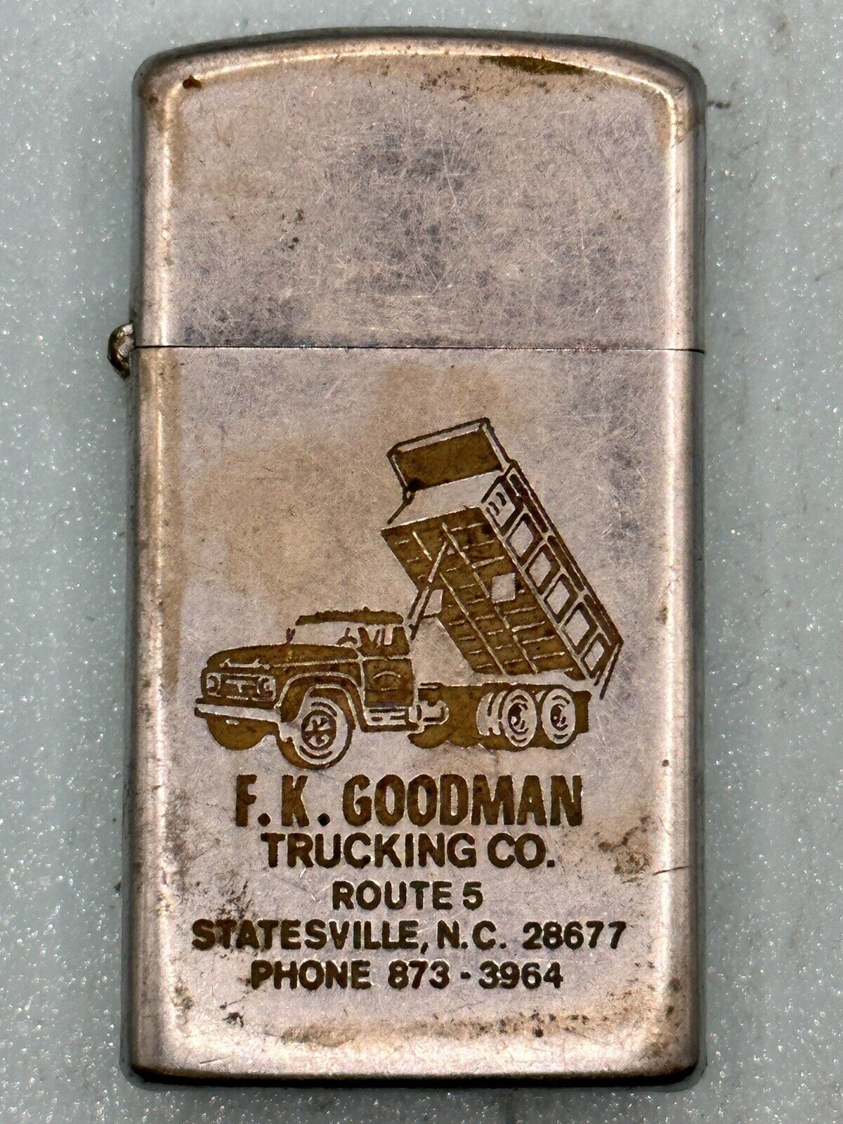 Vintage 1973 FK Goodman Trucking Advertising Chrome Slim Zippo Lighter