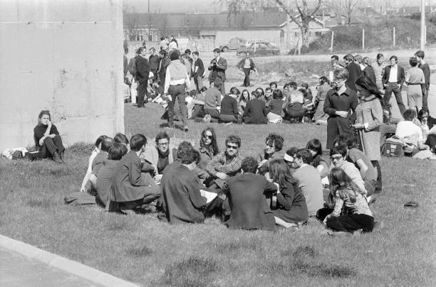 Groups students sitting floor chat sun outside striking univer- 1968 Old Photo