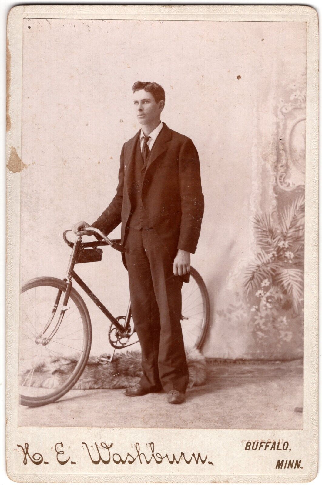 CIRCA 1890s CABINET CARD K.E. WASHBURN YOUNG MAN IN SUIT WITH BIKE BUFFALO MINN.
