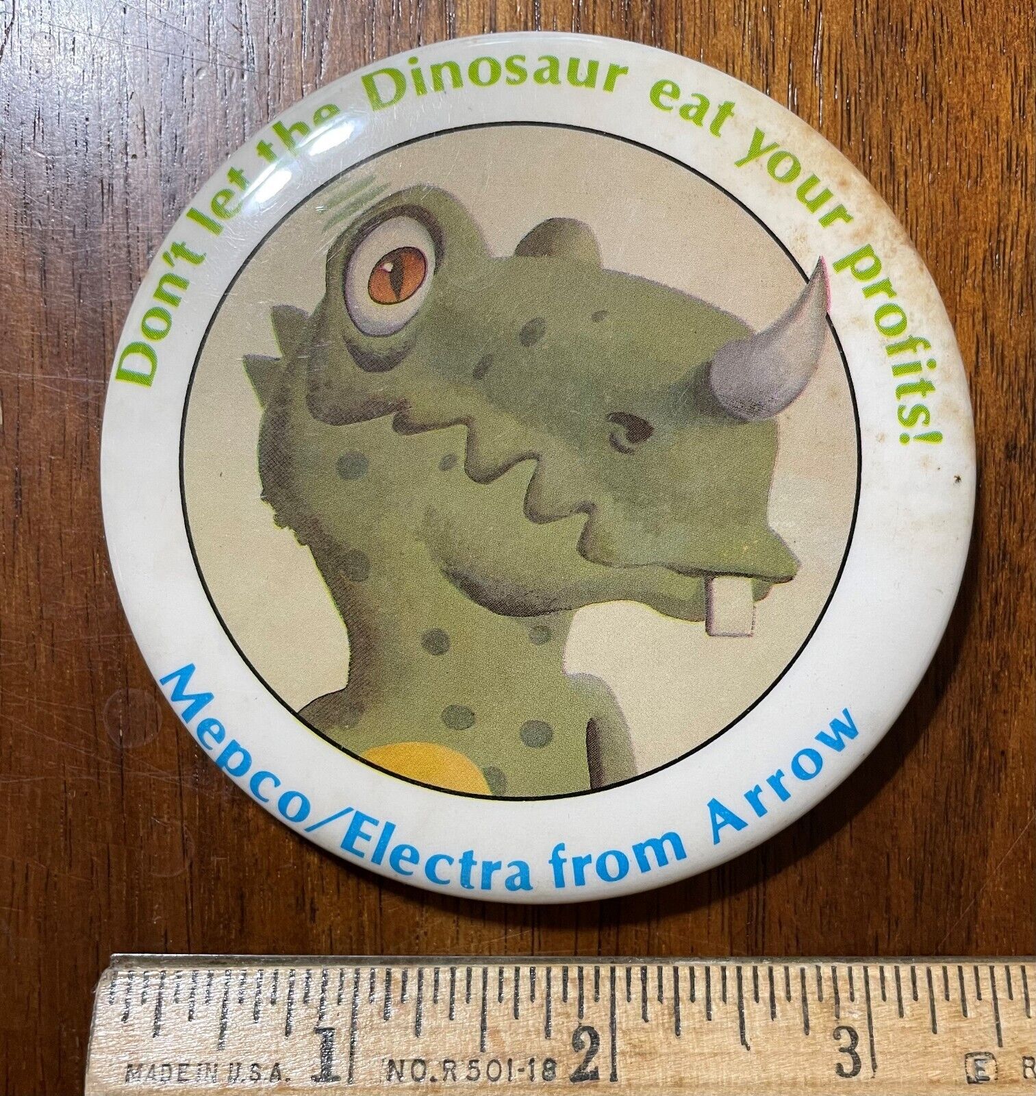 1970\'s Mepco / Electra 3 1/2 Pinback Button Dinosaur Eating Profits Vintage