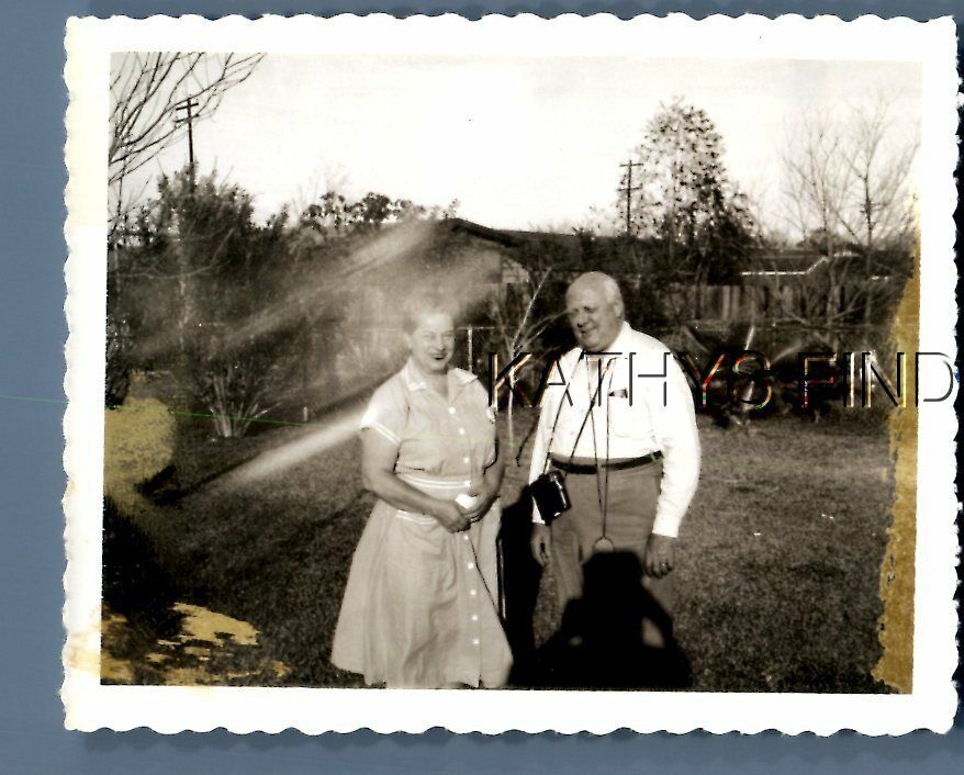 FOUND B&W POLAROID H+9640 MAN POSED WITH PRETTY WOMAN IN DRESS,LIGHT ANOMALY