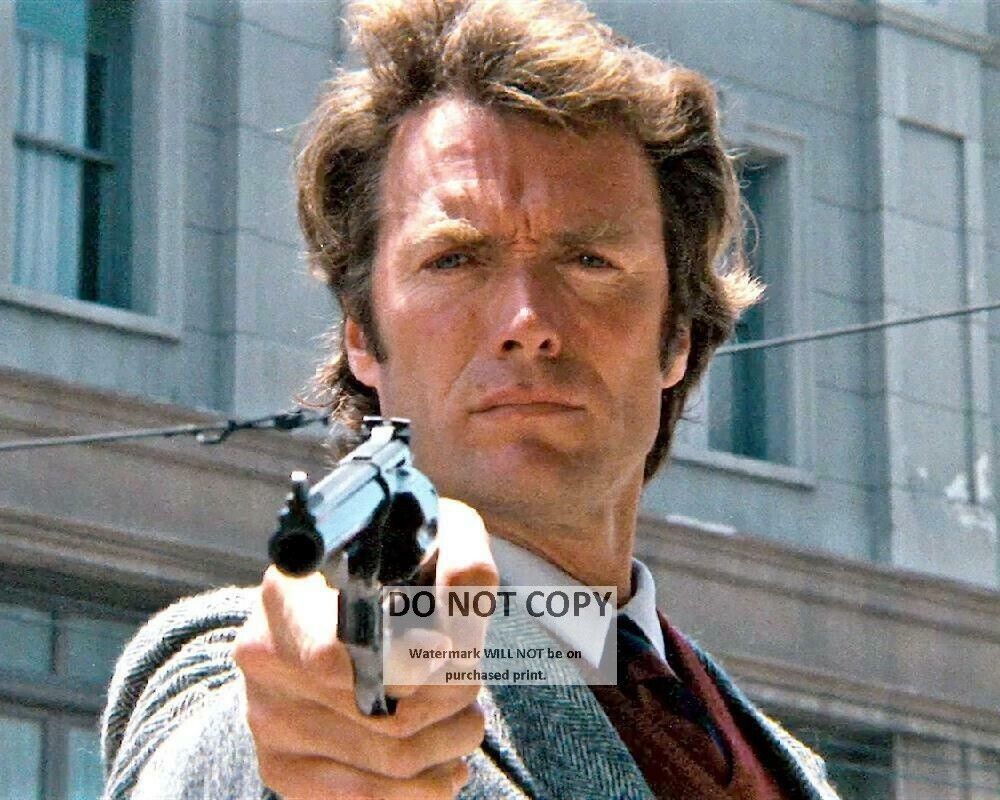 CLINT EASTWOOD BRANDISHING HIS .44 MAGNUM IN 