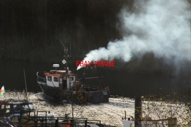 PHOTO  THE FISHING BOAT OUR LOUISE PUMPING OUT SOME DIESEL FUMES ON THE RIVER EL