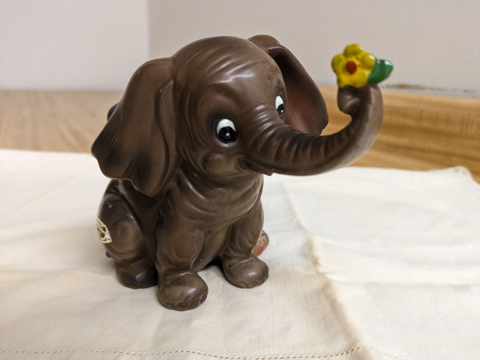Vtg. Josef Originals brown elephant holding flower figurine