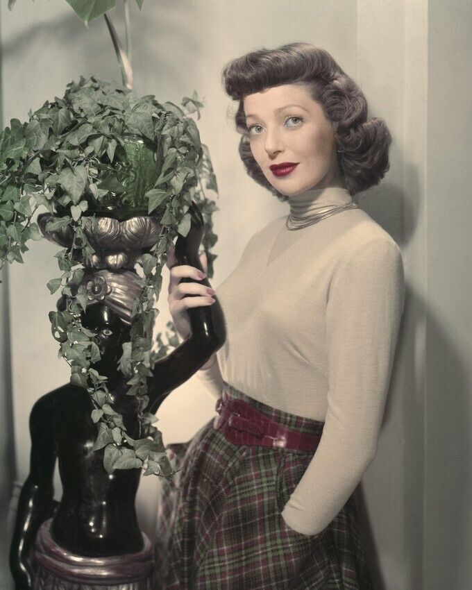 Loretta Young Sweater Plaid Skirt Posing By Plant Statue 8x10 inch photo