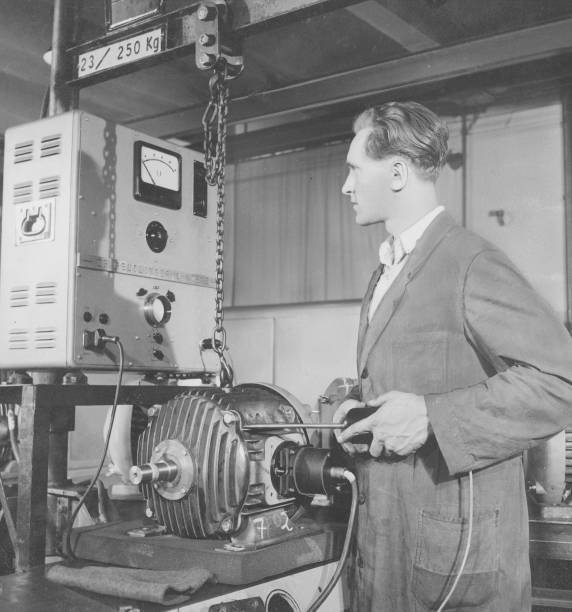 Worker tests a low vibration electric motor with a vibration meter- Old Photo