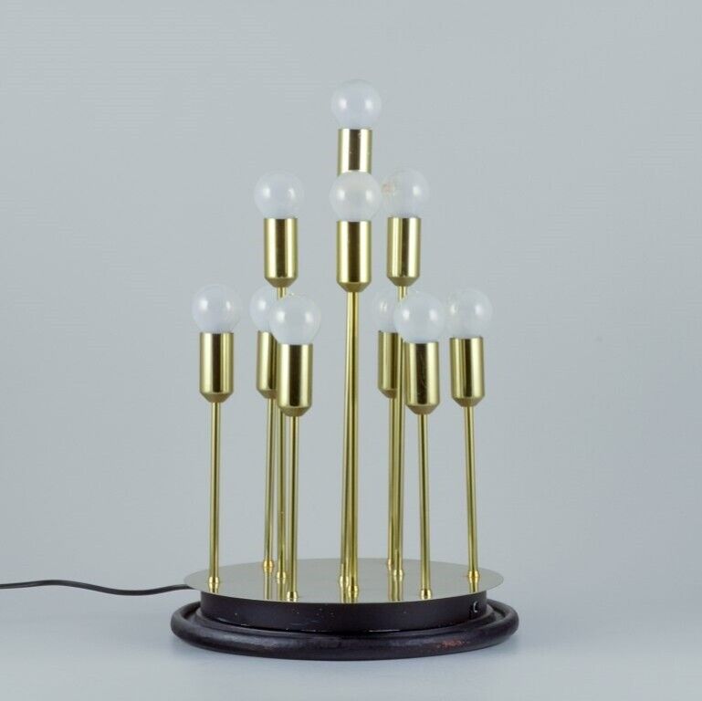 Sülken Leuchten. Modern lamp for ten bulbs. Brass on a black wooden base.