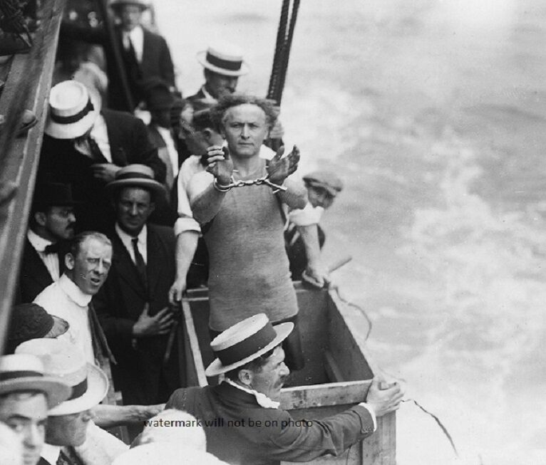 Harry Houdini shows his handcuffs; submerged into East River 8