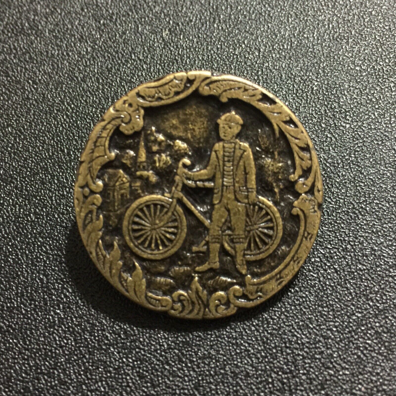Vintage Brass Button Man Standing Next to Bicycle Framed by Floral Design