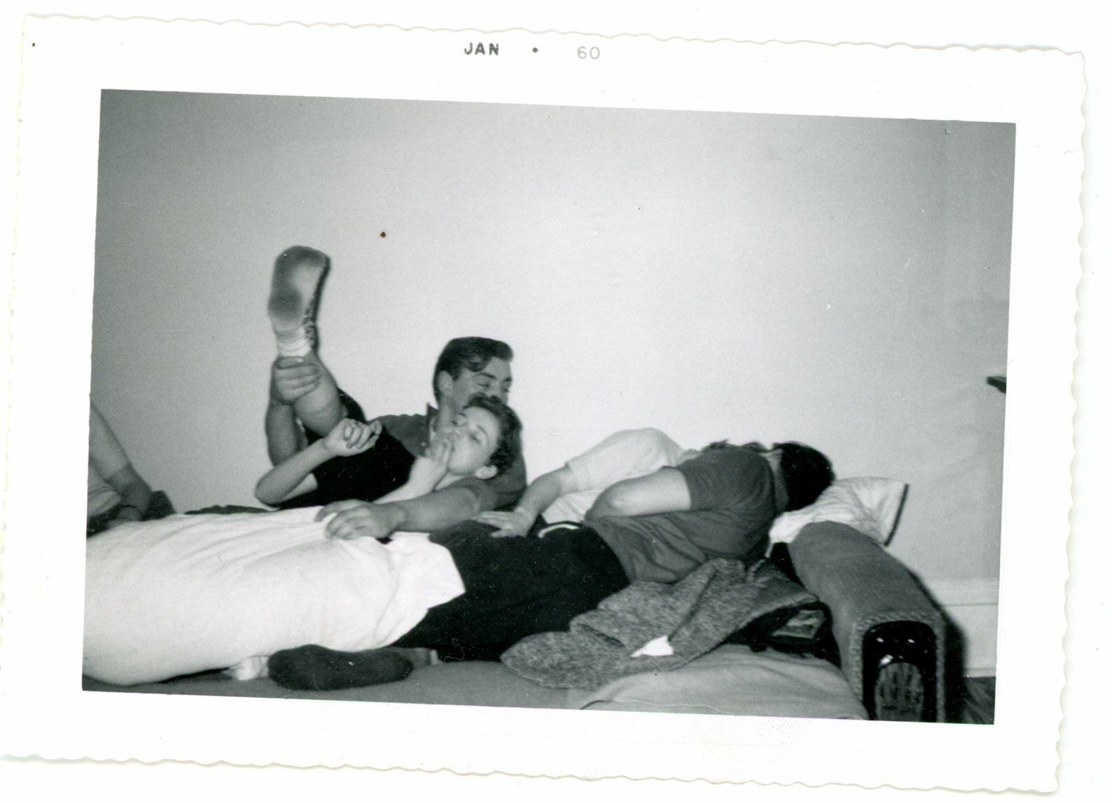 Frisky couples entangled on bed -  vintage snapshot found  photo