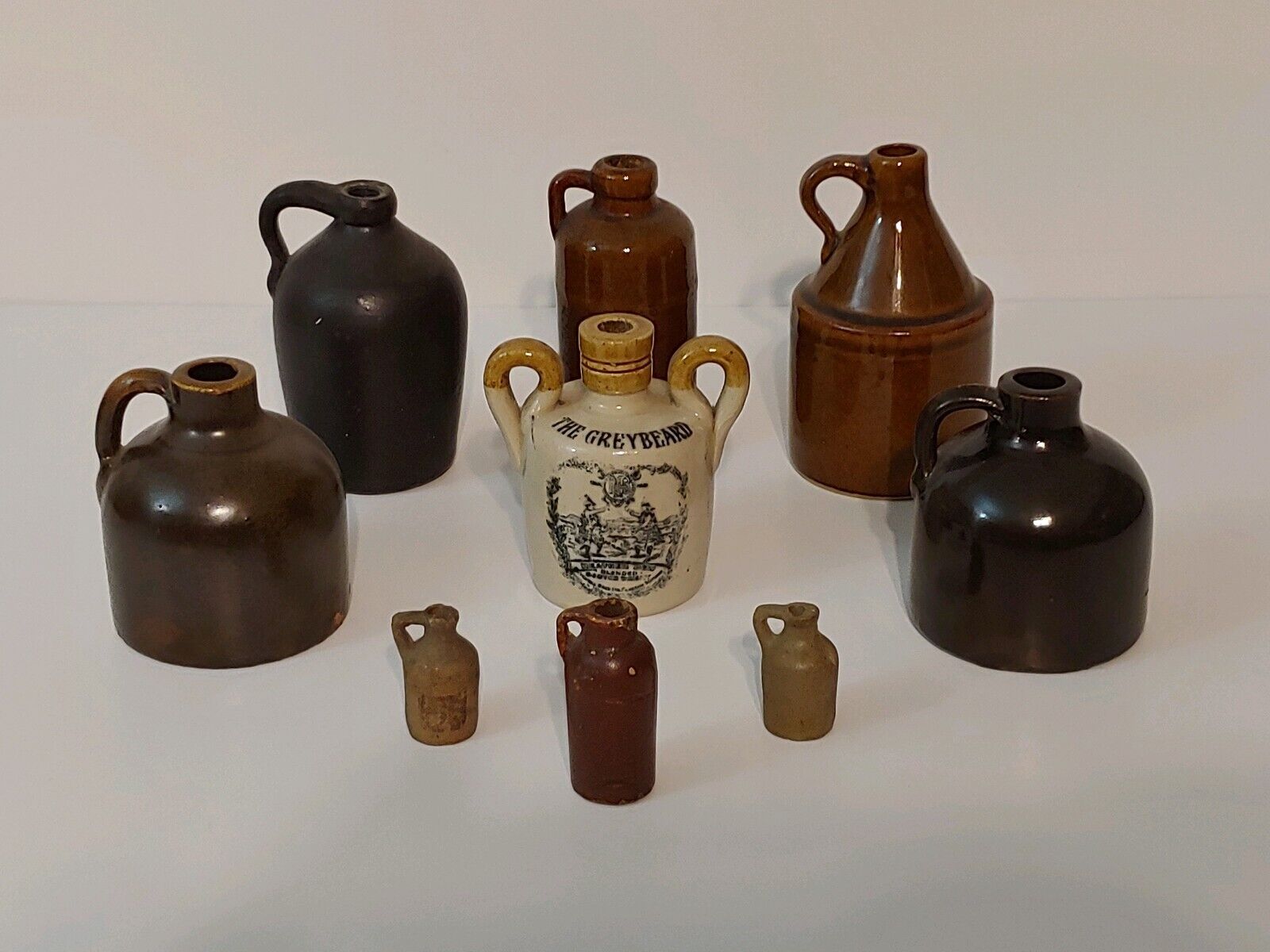 Lot of 9 Antique Small Stoneware Whiskey Rum Moonshine Jugs GREYBEARD + 2 MORE