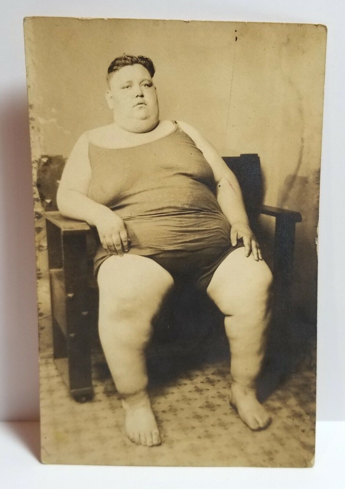 Fat man circus freak, obese man in chair, photo, circa 1915