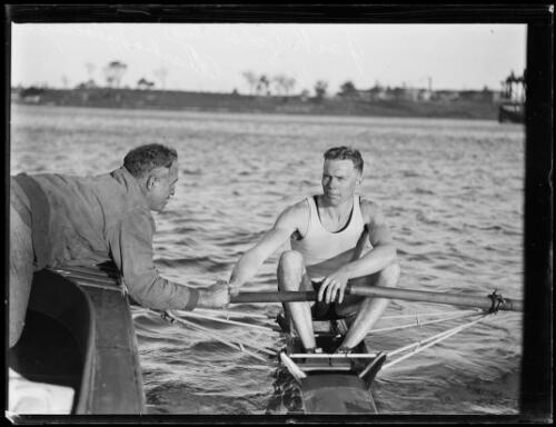 Charlie Messenger leaning over to shake the hand of rower Jack Gol- Old Photo