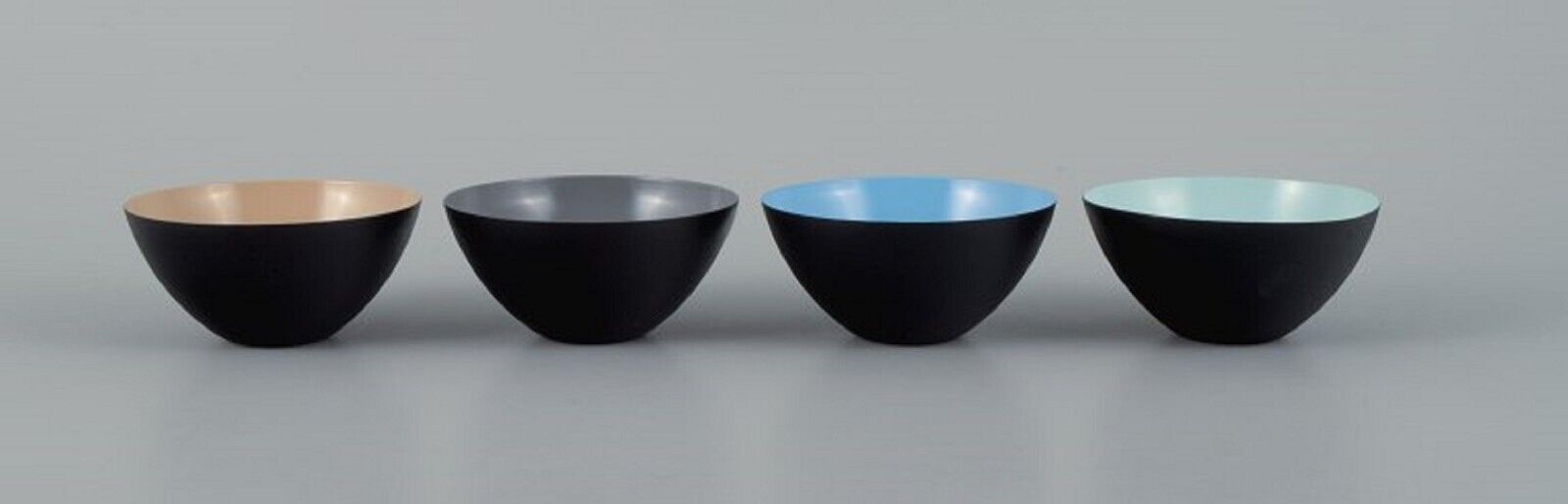 Four small Krenit bowls in metal. Brown, grey, blue and mint green.