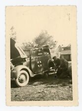 German WW2 Photo Soldiers Change Tire On Red Cross Marked Staff Car picture