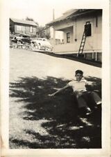 Vintage Photograph Boy lying on grass near street with antique cars picture