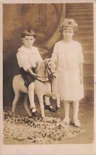 RPPC Boy Rides Studio Prop Horse with Sister in Vintage Portrait Postcard picture