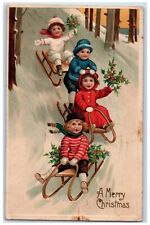 1912 Christmas Sledding Childrens Holly Berries Winter Snow Embossed Postcard picture