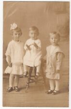 100721 VINTAGE RPPC STUDIO REAL PHOTO POSTCARD THREE YOUNG CHILDREN IN WHITE picture
