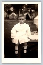 c1915 RPPC Postcard: Kid Sits On A Table, Tents In The Background - Summertime picture
