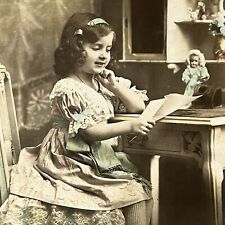 Vintage RPPC Postcard Adorable Little French Girl Reading Letter With Doll picture