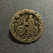 Vintage Brass Button Man Standing Next to Bicycle Framed by Floral Design picture