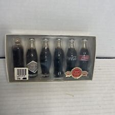 Evolution of the Coca-Cola contour bottle with six Minico bottles.  34 picture