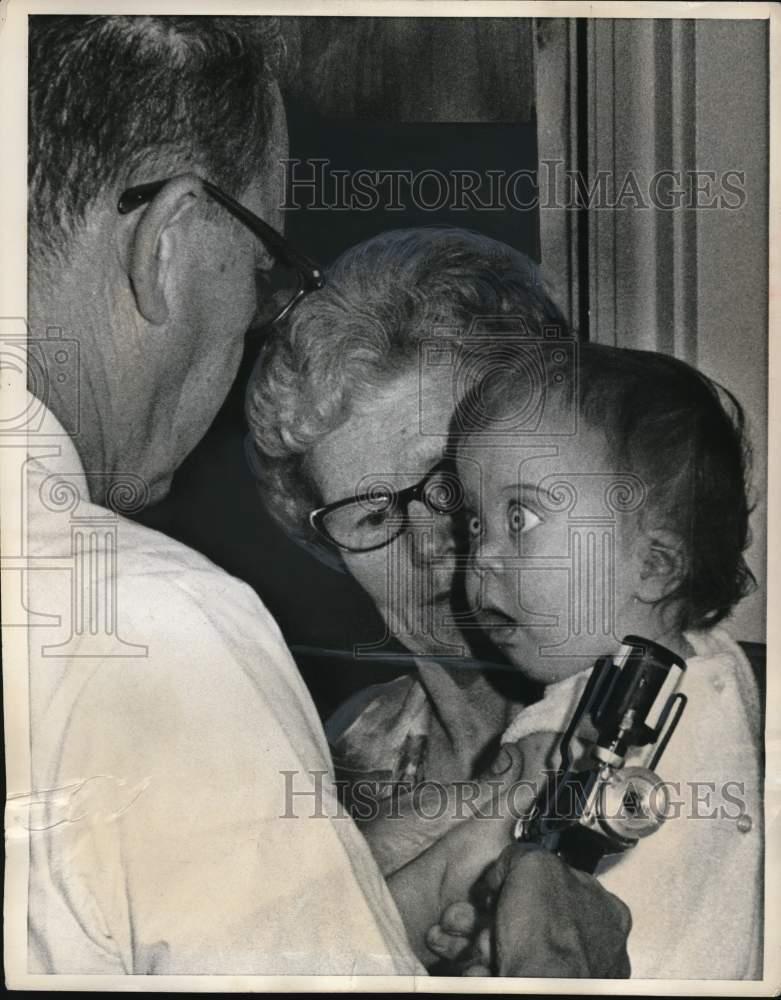 1969 Press Photo Shocked youngster gets an injection against measles, Milford CT