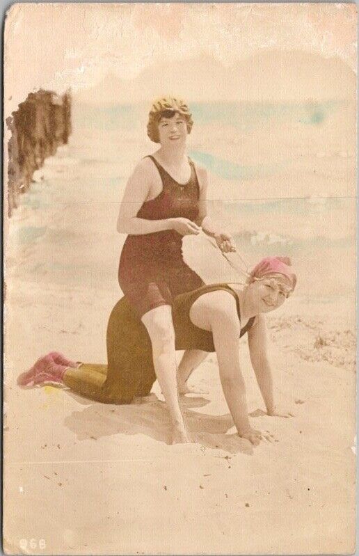 c1920s RPPC Postcard Bathing Suit Girl Riding Friend like a Horse Colored Photo