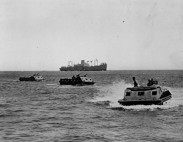 Amphibian tractors come ashore at Guadalcanal. off the shore of Gu- Old Photo