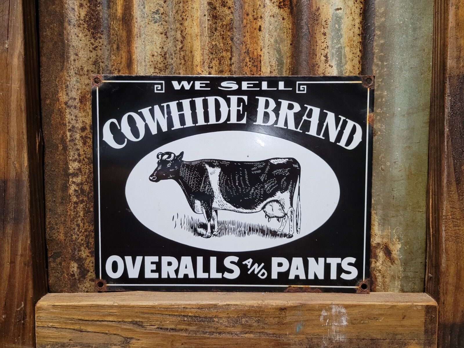 VINTAGE COWHIDE OVERALLS PORCELAIN SIGN COWBOY RODEO PANTS CLOTHING COMPANY COW