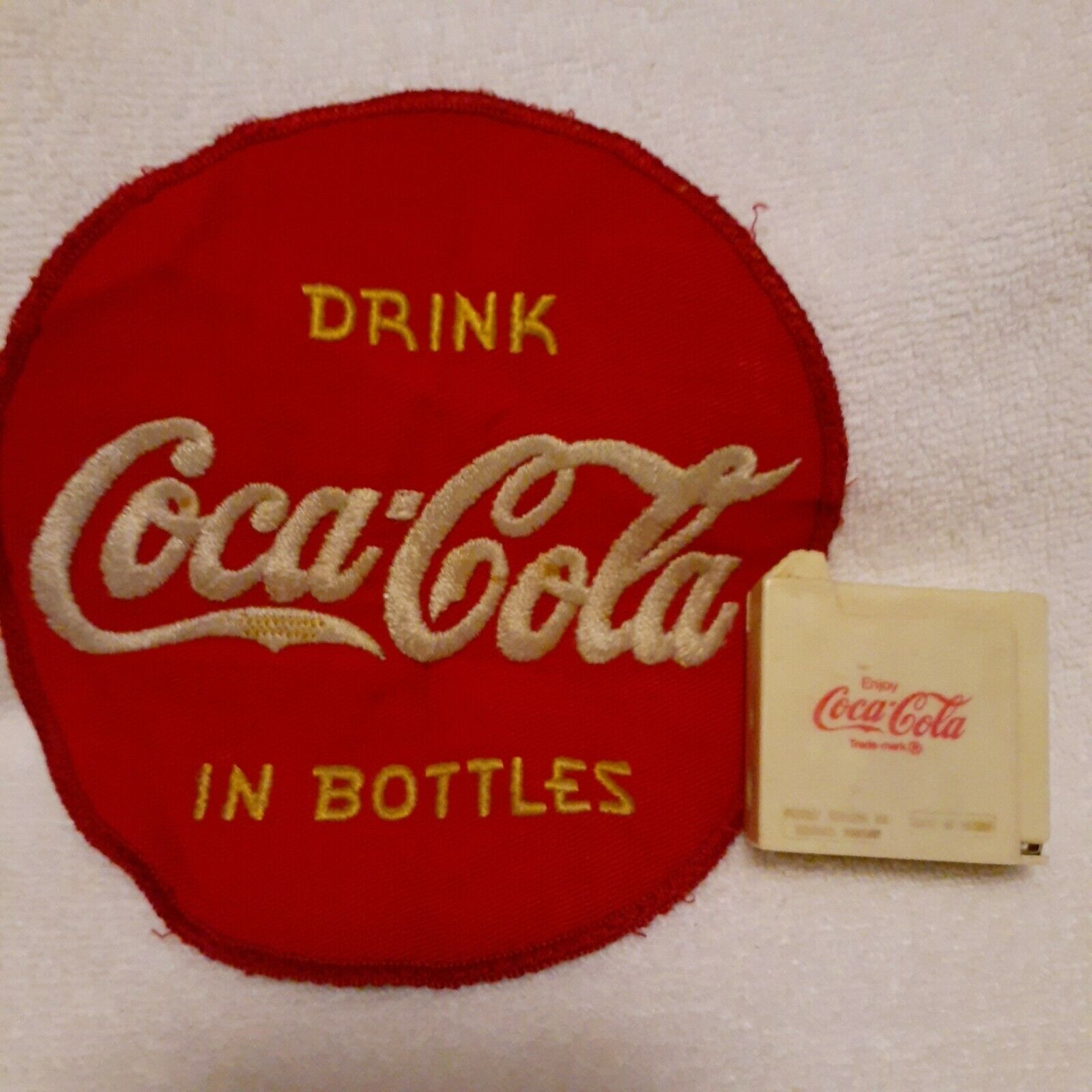 Vintage Coca-Cola battery tester and large embroidered uniform patch