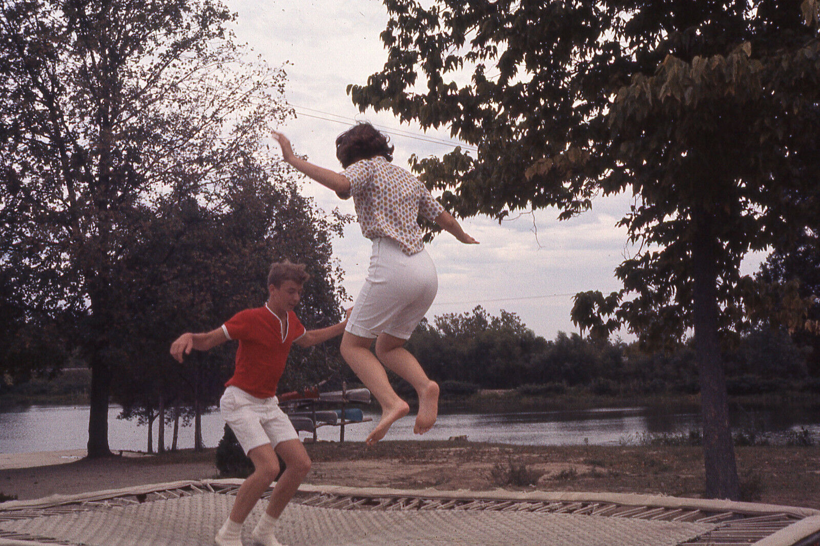 TEENAGE BOY & GIRL JUMPING ON A TRAMPOLINE 1965 PHOTO SLIDE