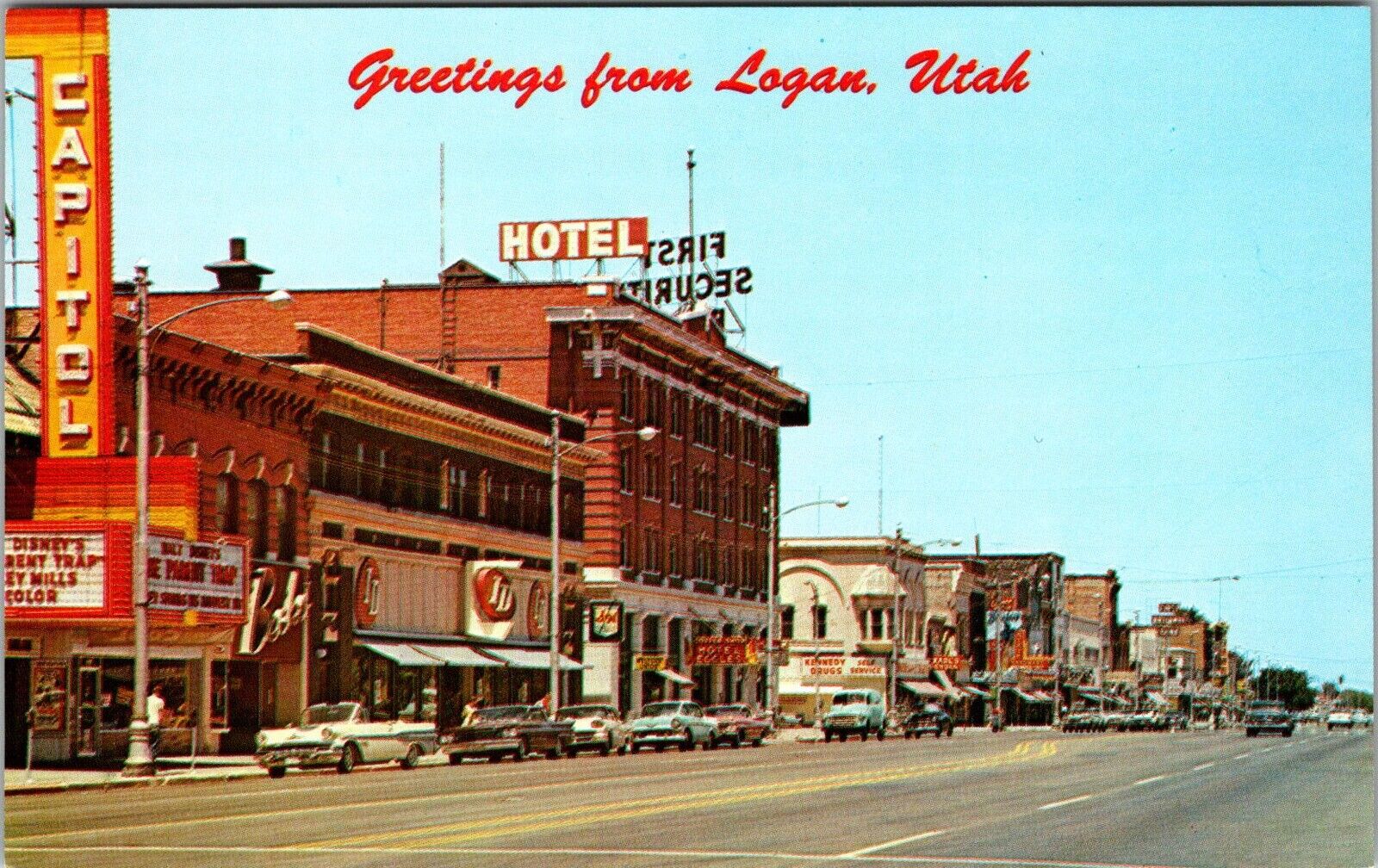 Logan  Utah, Main Street 1960’s Cars~Hotel ~vintage postcard KA15