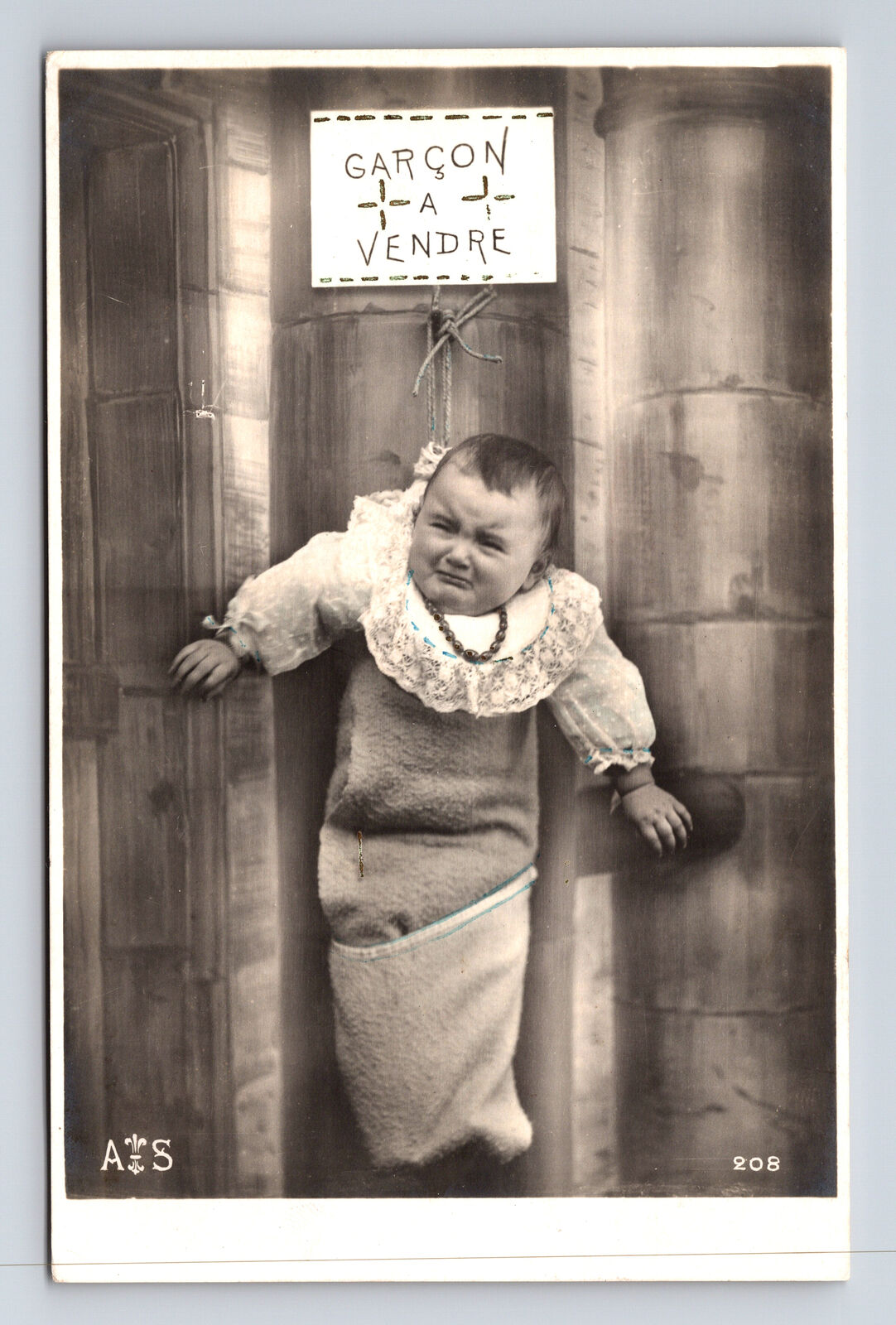 RPPC French Garcon a Vendre Unhappy Boy Baby For Sale Dark Humor Postcard