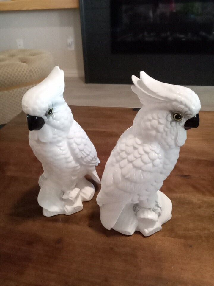 Vintage pair of hand painted porcelain cockatoo statues.