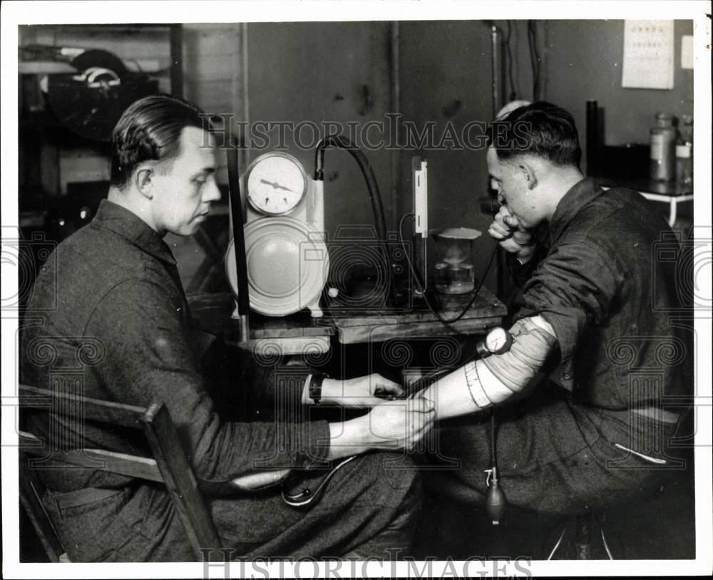 1968 Press Photo Pilot gets blood pressure checked while in hypoxic state