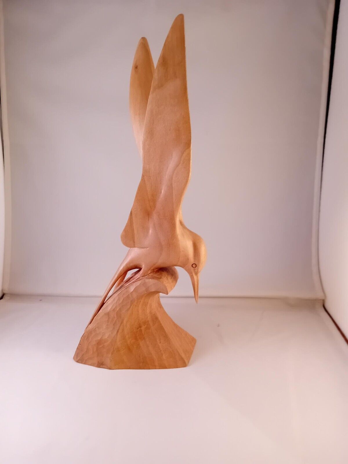 A Tern carved out of one piece of Lime wood riding the crest of a wave