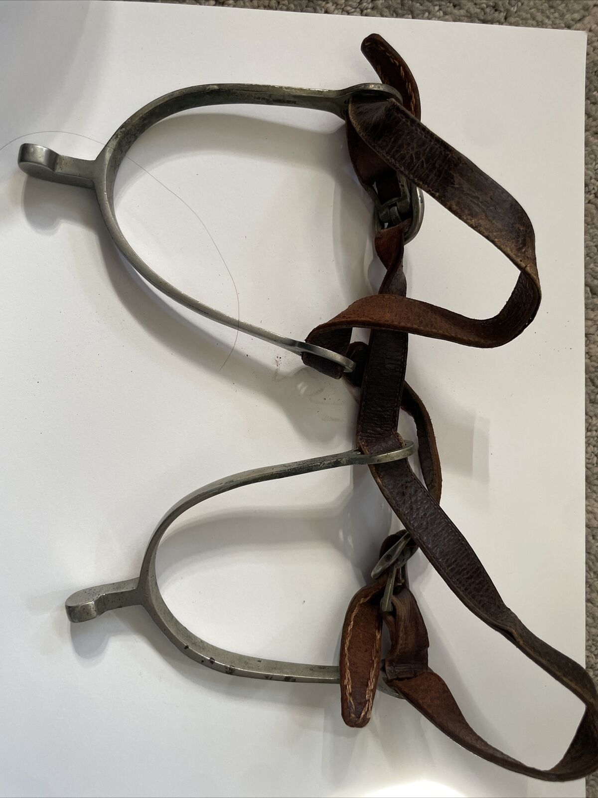 Antique set of spurs with original leathers