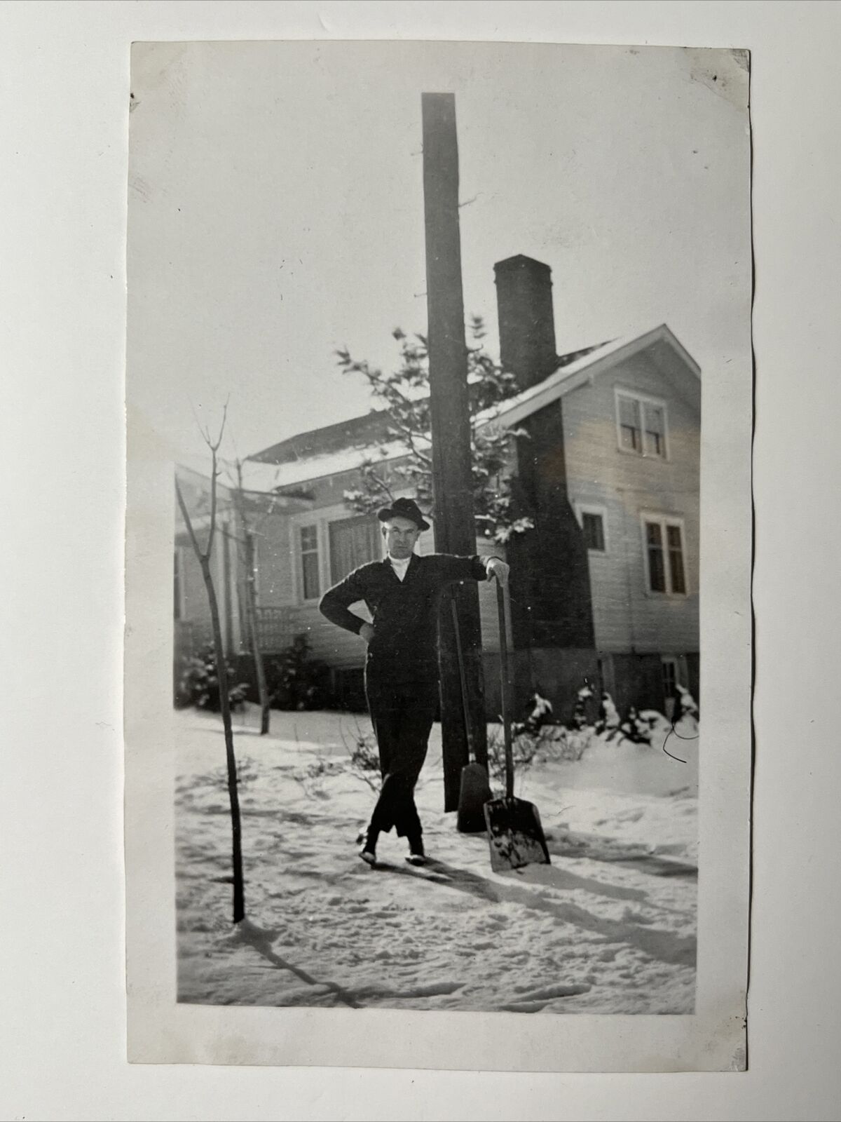 1930s MAN Shoveling SNOW outside of HOUSE Snapshot Photo posing w SNOW SHOVEL