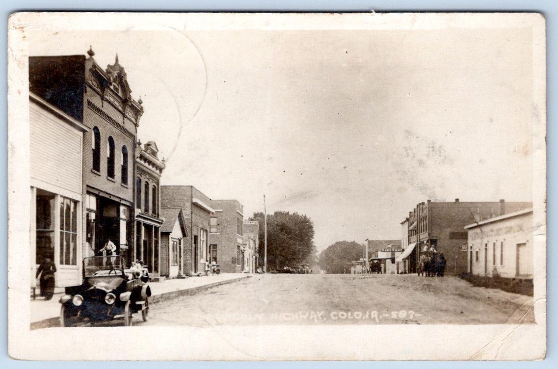 1916 RPPC COLO IOWA LINCOLN HIGHWAY STOREFRONTS CAR DIRT ROAD DOWNTOWN HORSES