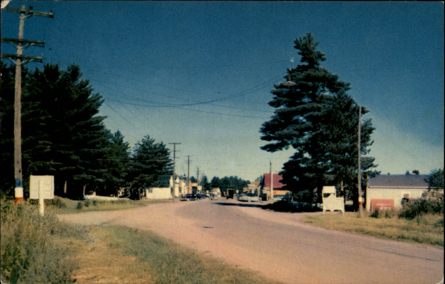 Street to business district Land O\'Lakes Wisconsin ~ 1950s cars vintage postcard
