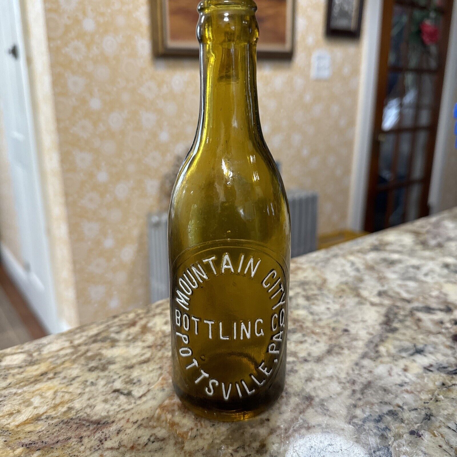 vintage yellow slug plate embossed crown top bottle,Mountain City bottling co.