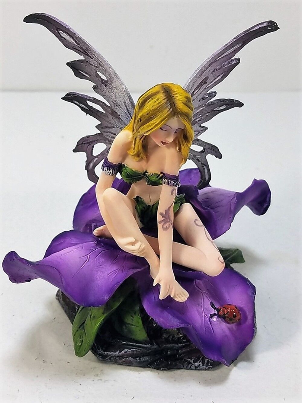 91653 Purple Winged Fairy Sitting on Flower Petals by Backwoods Lighting LLC