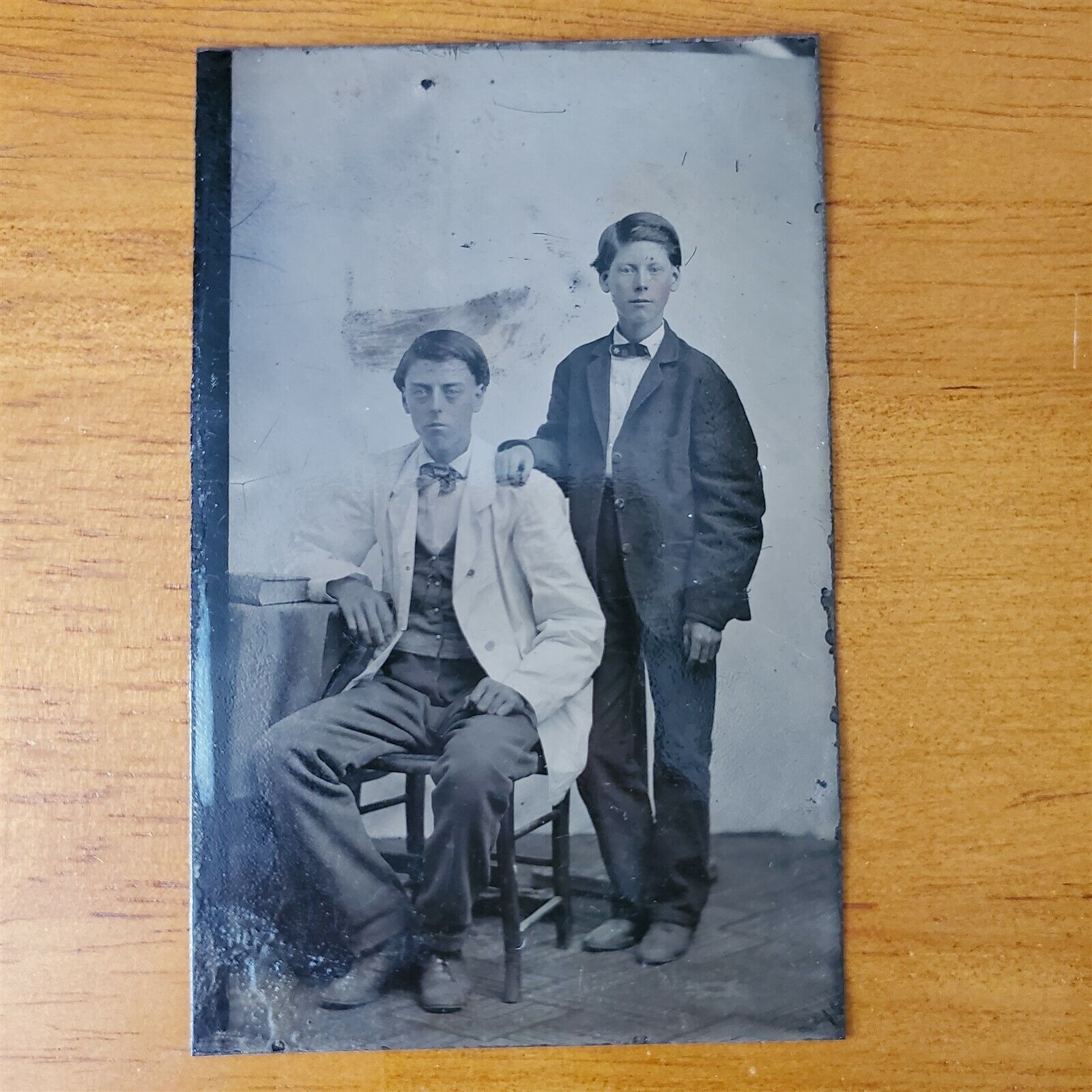 Antique 1800s Tintype Photo Two Adolescent Brothers in Coats Posed by Table
