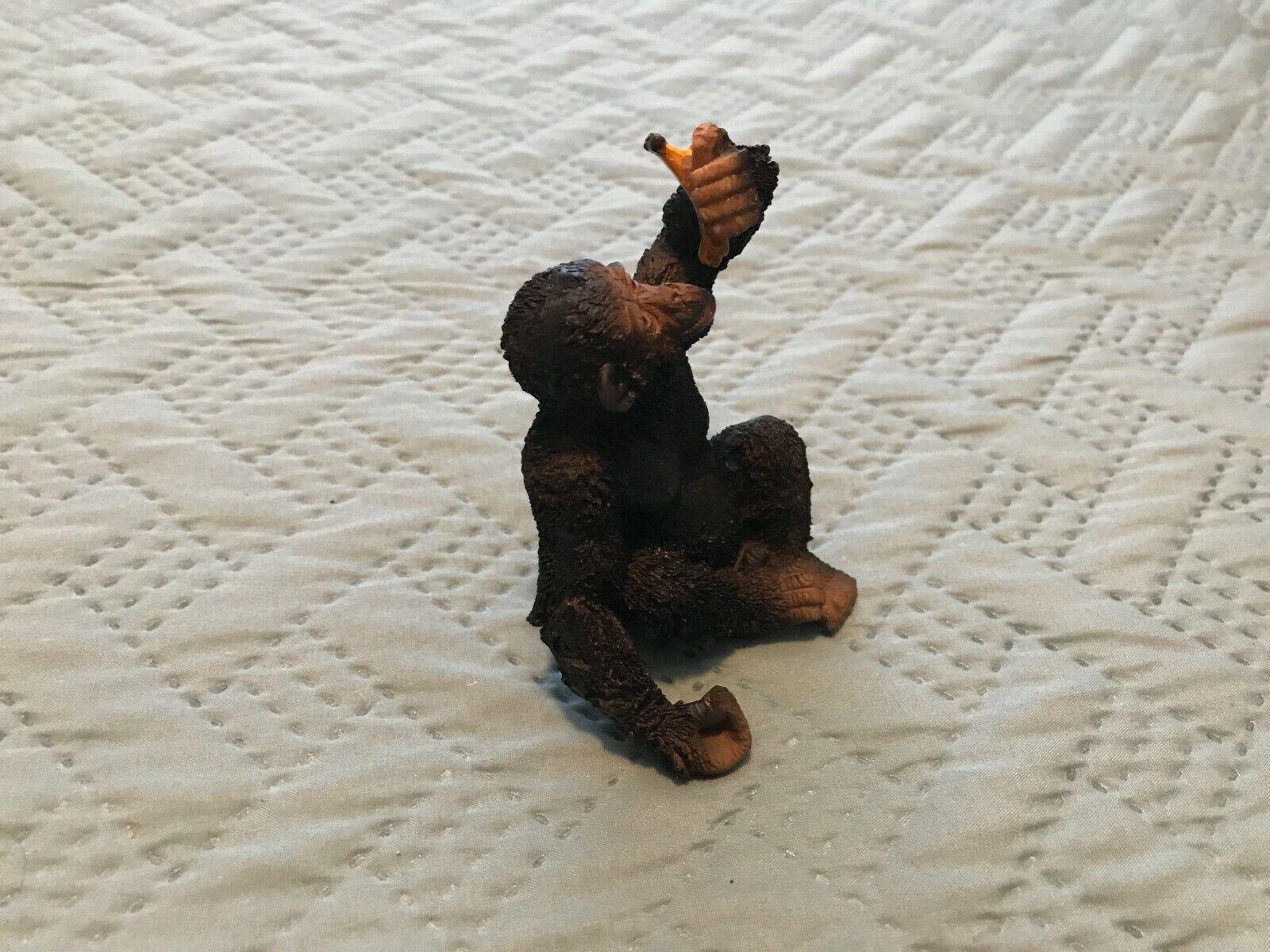 Monkey ( Chimp ) Figurine Holding A Banana And Eating it 