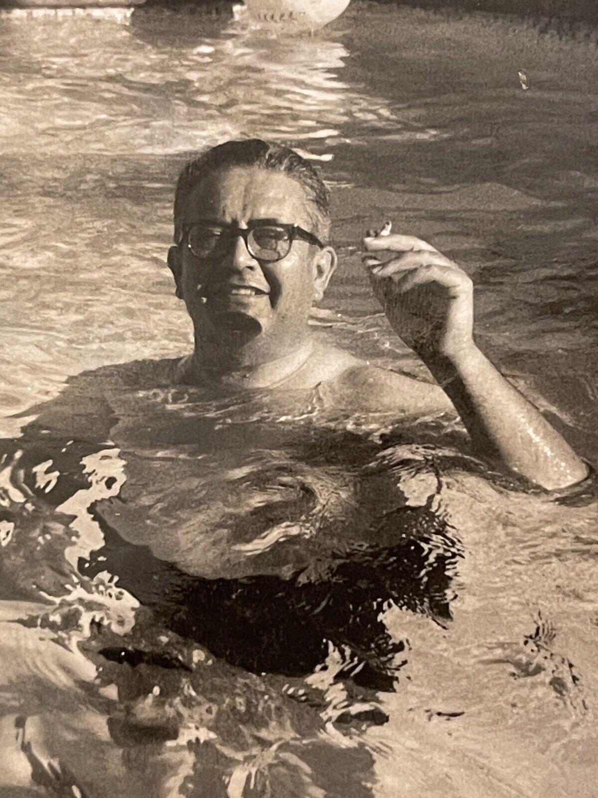 Vintage Photo Man in Pool Holding Cigarette Above Water Ball Floating Behind Him